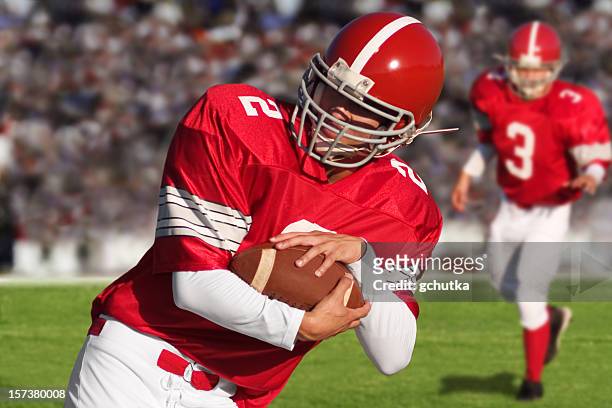 football players on field - american football uniform stock pictures, royalty-free photos & images