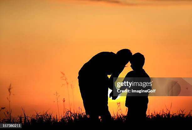 mother and child silhouette in rural setting - mother son talking silhouette stock pictures, royalty-free photos & images