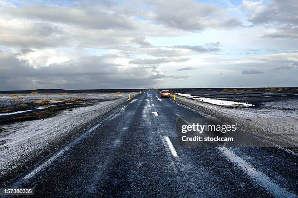 road with snow disappearing at the horizon, iceland - hailstorm stock pictures, royalty-free photos & images