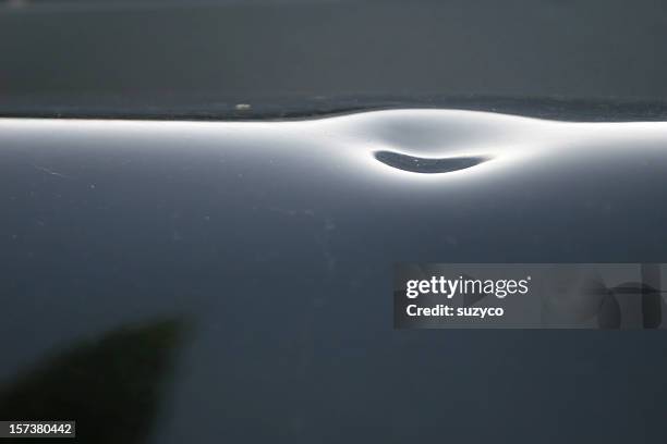 damage on car surface done by hail - damaged car stock pictures, royalty-free photos & images