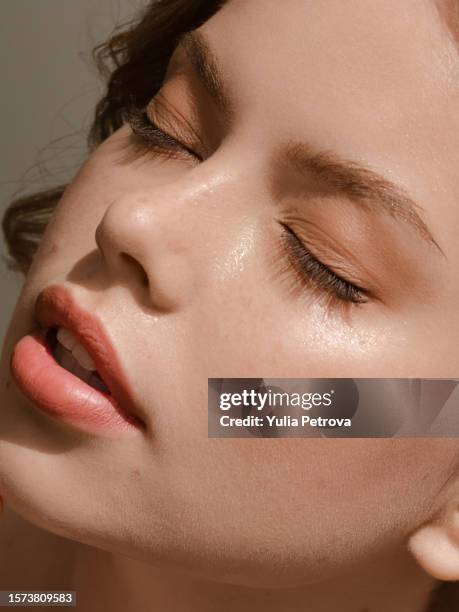 close-up portrait of a woman with clean, moist skin in the sunlight - natural condition stock pictures, royalty-free photos & images