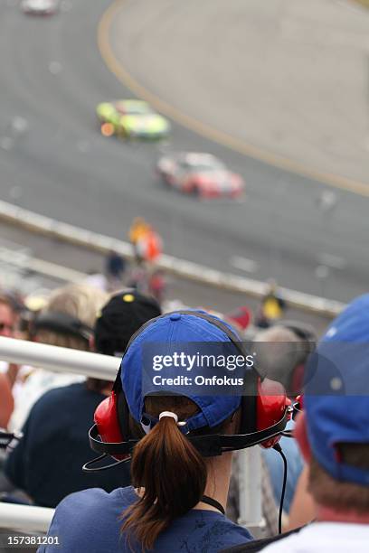 woman fan at racing event and looking at race - watching nascar stock pictures, royalty-free photos & images