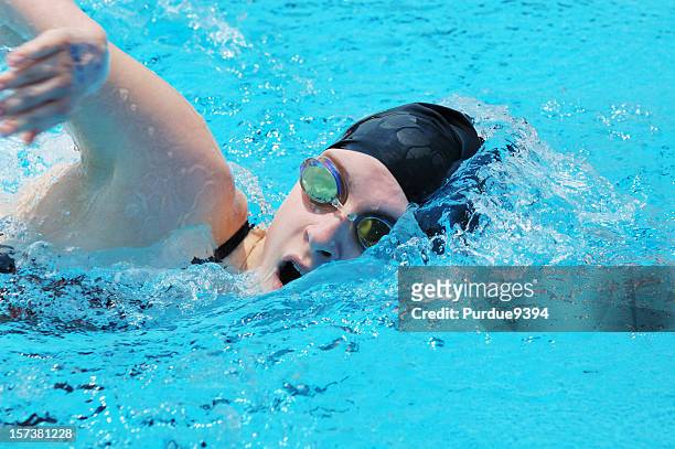 teenage female front crawl freestyle swimmer up close - swimming free style pool stock pictures, royalty-free photos & images