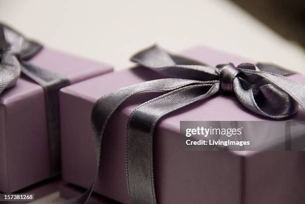 lavender gift box with a dark purple satin bow - wrapping paper stock pictures, royalty-free photos & images
