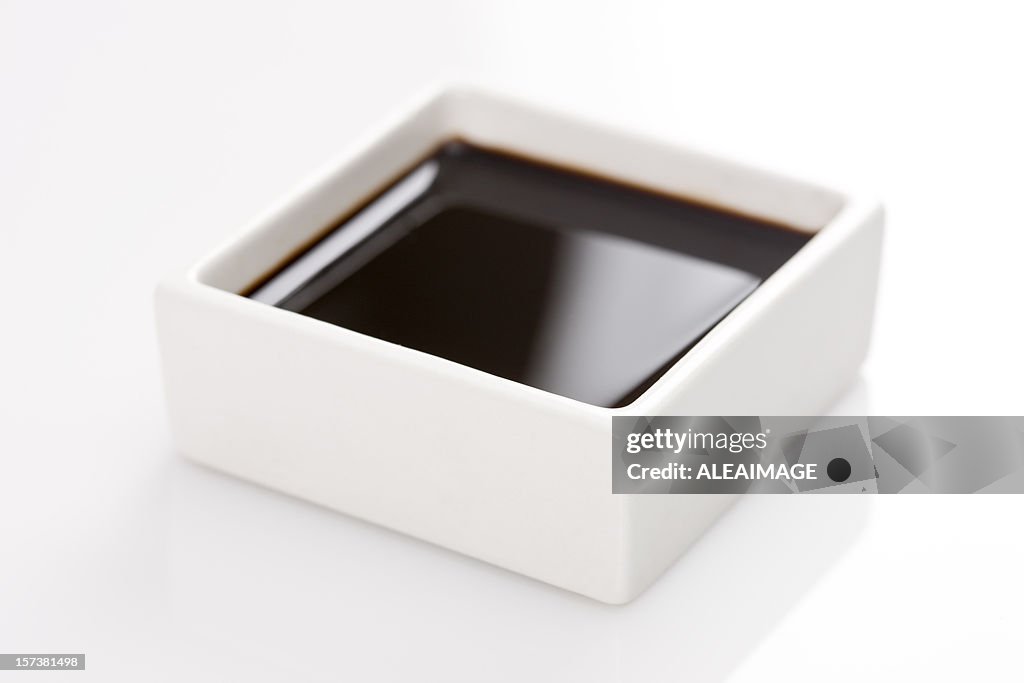 A square container of soy sauce