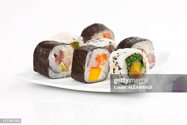 sushi rolls on a white plate with white background - maki sushi stockfoto's en -beelden