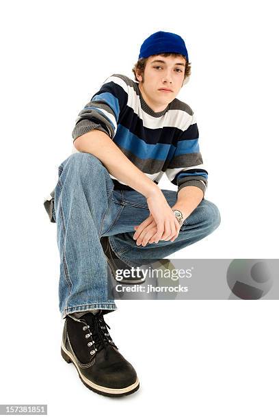 cool casual teen crouching - teenage boy in cap posing stock pictures, royalty-free photos & images