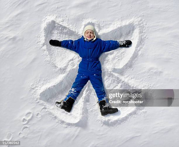 snow angel - kid eyes closed stock pictures, royalty-free photos & images