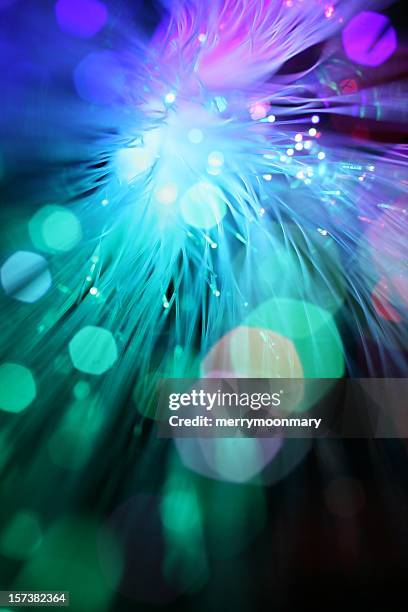 close-up bokeh of optical fibers in purple and teal - fun background stock pictures, royalty-free photos & images