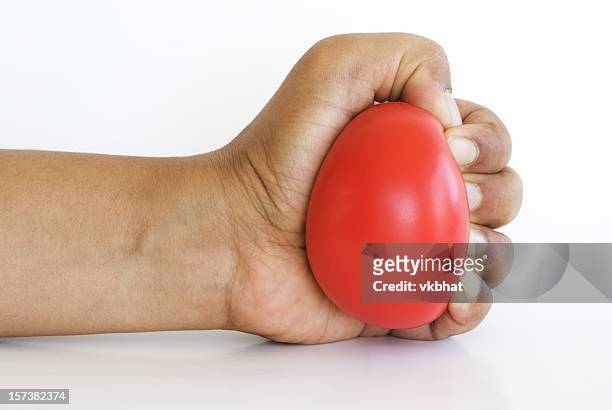 hand squeezing stress ball - stress ball stock pictures, royalty-free photos & images