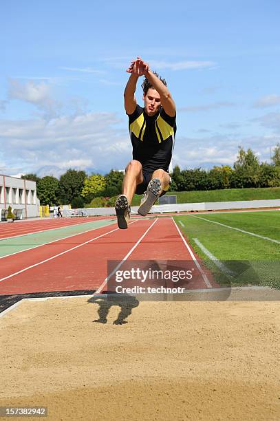 long jump action - long jump stock pictures, royalty-free photos & images