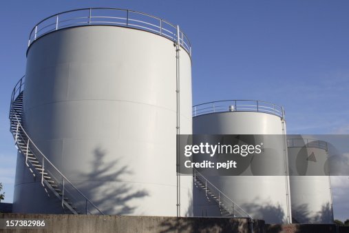 White oil tanks for storing fuel appear to be blank canvases