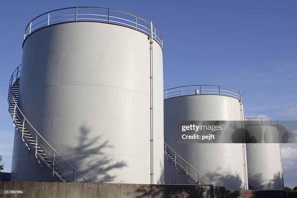 White oil tanks for storing fuel appear to be blank canvases