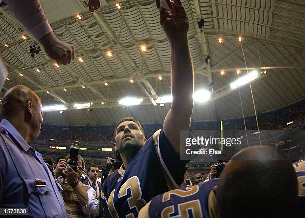 Quarterback Kurt Warner of the St. Louis Rams hands his gloves to a fan after they beat the Atlanta Falcons at the Dome at America's Center in St....