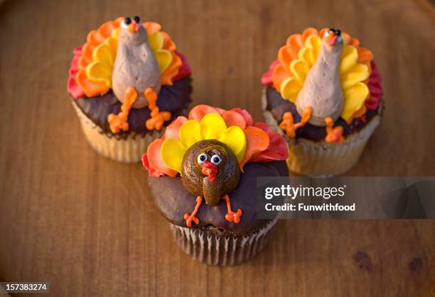 chocolate thanksgiving holiday dessert background, turkey cupcakes on table - thanksgiving indulgence stock pictures, royalty-free photos & images