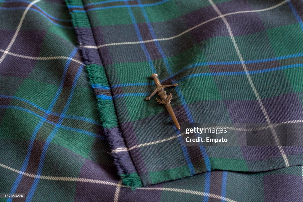 Close up view of Tartan Kilt and kiltpin.