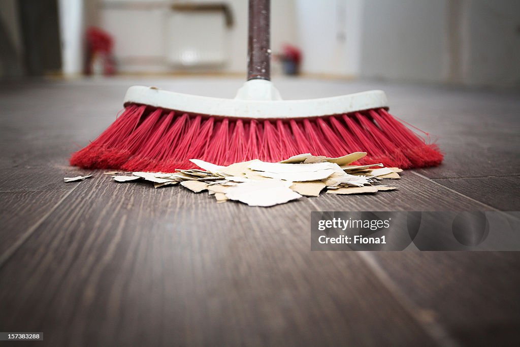 Sweeping floor with broom