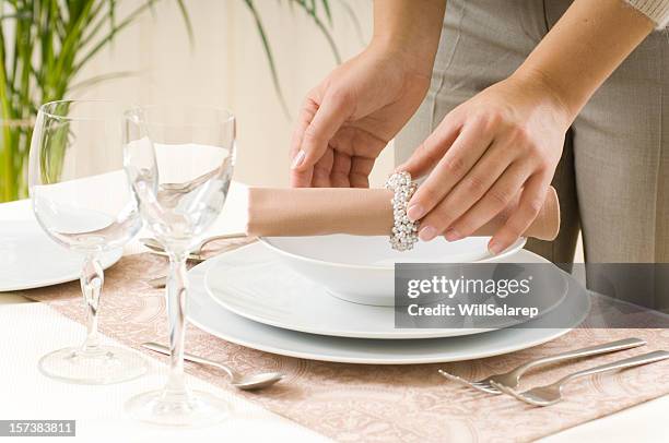 woman preparing a dinner table - place mat stock pictures, royalty-free photos & images