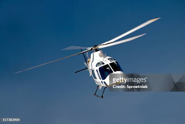 high-banking helicopter - helicopter stock pictures, royalty-free photos & images