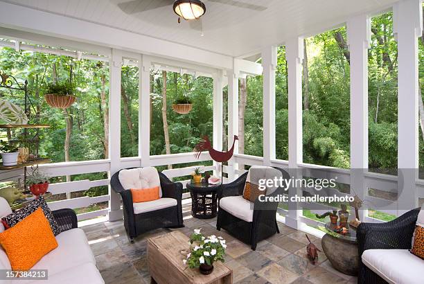 peaceful enclosed back deck/porch with furniture - afgesloten ruimte stockfoto's en -beelden