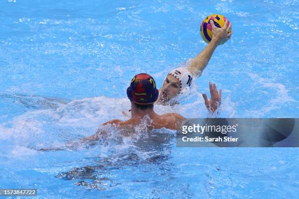Denes Varga of Team Hungary shoots against Alberto Munarriz Egana of Team Spain in the Men's Water Polo Semifinal match between Hungary and Spain on...