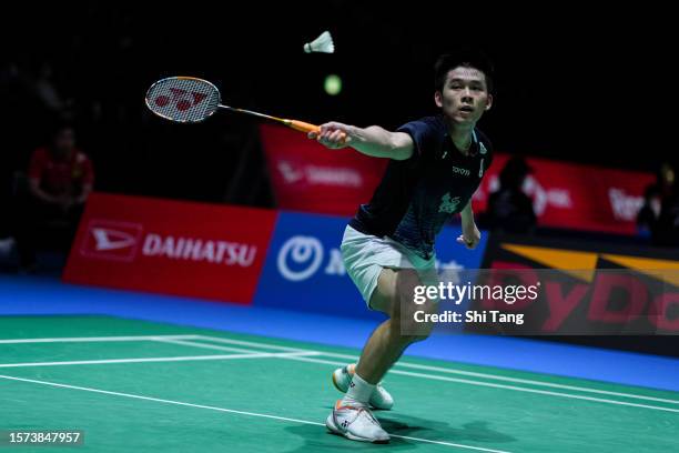 Kunlavut Vitidsarn of Thailand competes in the Men's Singles Second Round match against Kenta Nishimoto of Japan on day three of the Japan Open at...