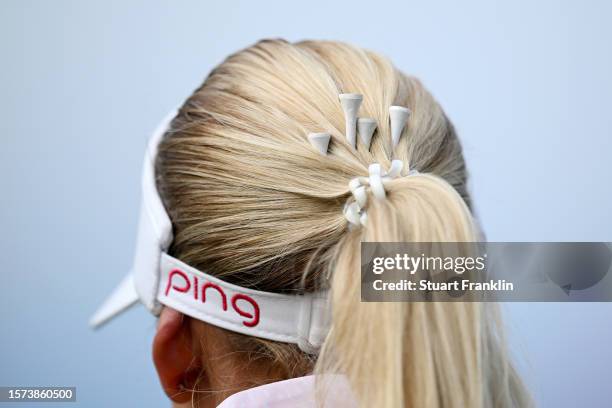 Detailed view of White Golf Tees in the ponytail hair of Pernilla Lindberg of Sweden on the 18th hole during the first round of the Amundi Evian...