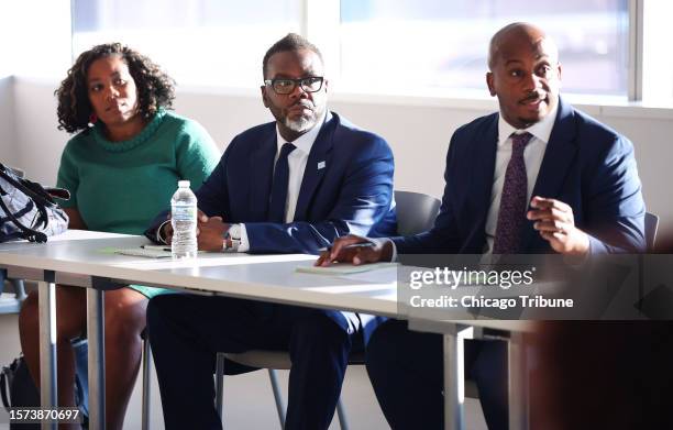 Budget Director Annette Guzman, left, and Chicago Mayor Brandon Johnson, center, listen July 18 during a community roundtable at Malcolm X College...