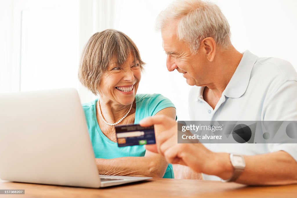 Happy senior couple buying on the internet