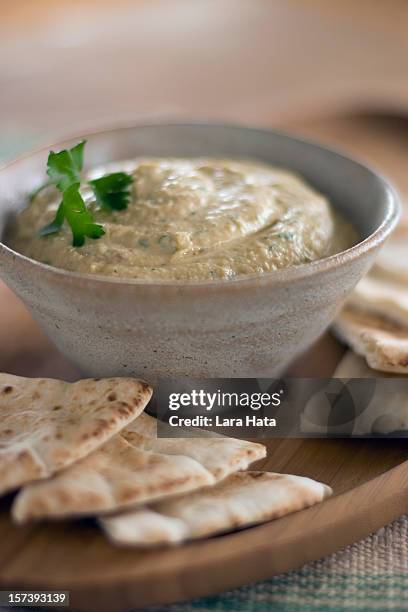 close-up of bowl of hummus with pita bread around it - pita bread stock pictures, royalty-free photos & images