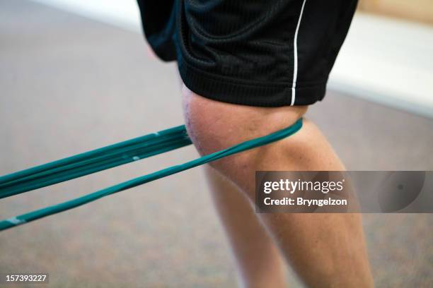 knee and resistance band - physiotherapy knee stock pictures, royalty-free photos & images