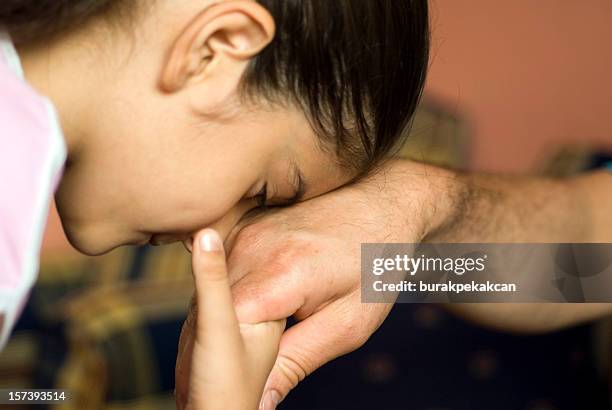 girl kissing father's hand, close-up, turkey, istanbul - kissing hand stock pictures, royalty-free photos & images