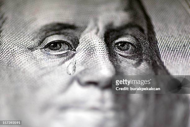 tear falling from face on us dollar bill, close-up - benjamin franklin 個照片及圖片檔