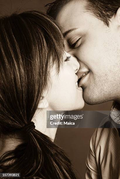 young couple kising - extreme close up kiss stock pictures, royalty-free photos & images