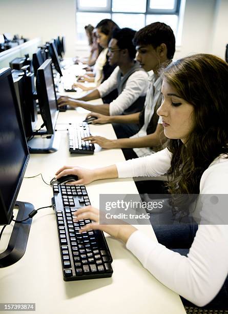 further education: teenage students candidly working in their computer lab - man and machine stock pictures, royalty-free photos & images