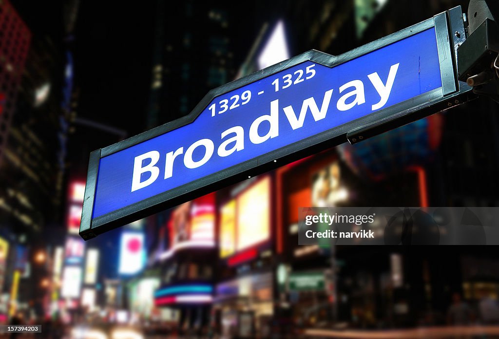Road Sign and Broadway Avenue Behind