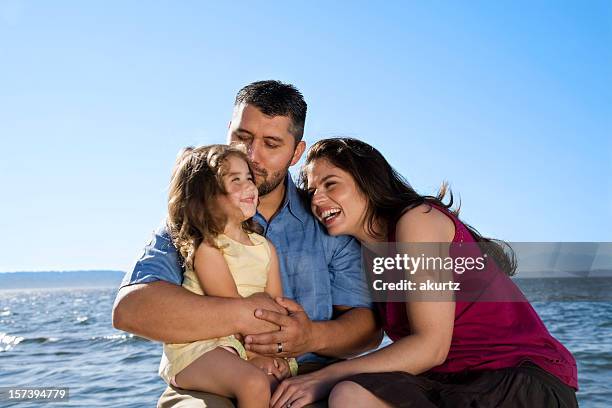 happy hispanic family playing ocean vacation mother father daughter - hot wife stockfoto's en -beelden