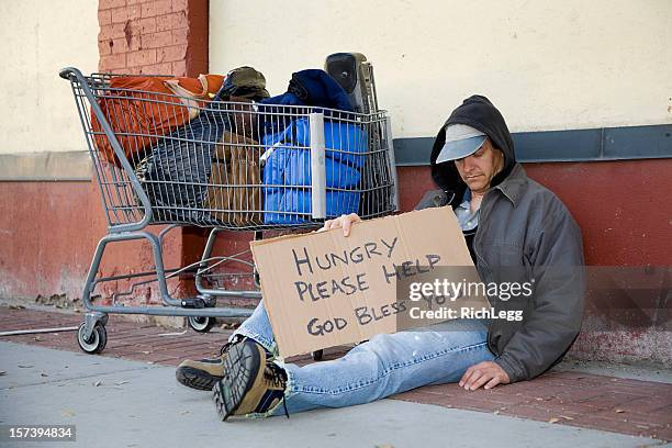 homeless couple on a city street - man sleeping with cap stock pictures, royalty-free photos & images