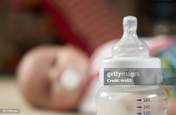 baby and bottle scale in focus - baby bottle stock pictures, royalty-free photos & images