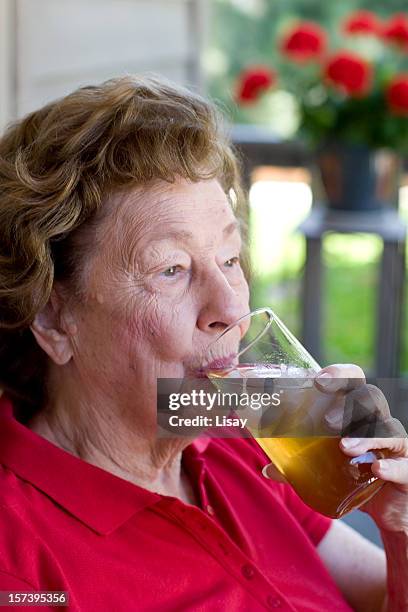 woman drinking ice tea - old lady drinking tea on porch stock pictures, royalty-free photos & images