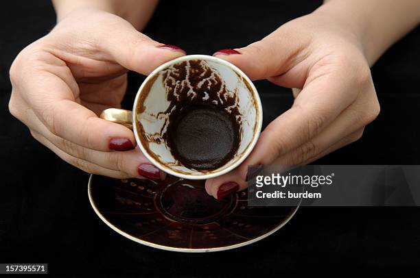 empty tea cup held to show the dregs by fortune teller - fortune telling stock pictures, royalty-free photos & images