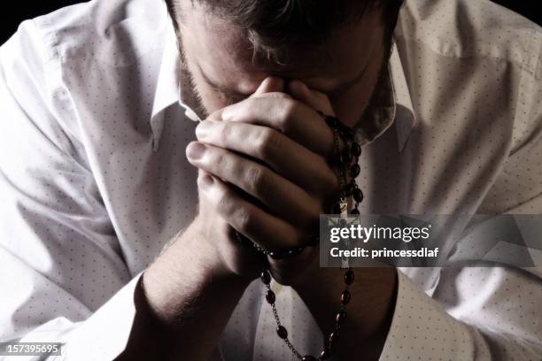 praying - rosary beads stock pictures, royalty-free photos & images