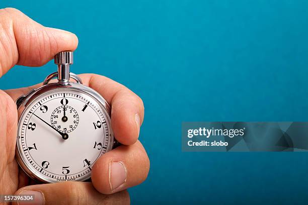 stop watch in hand - stop watch stock pictures, royalty-free photos & images