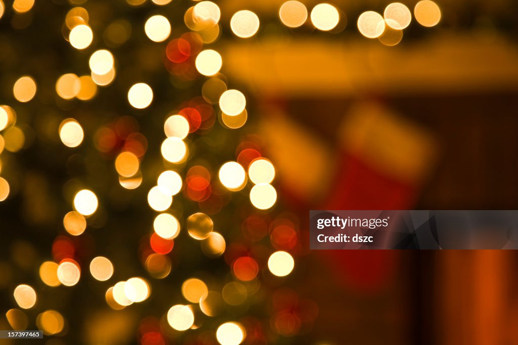 Christmas tree, and stockings hanging from mantel by fireplace