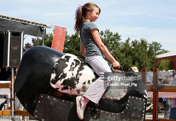 girl rides mechanical bull at rodeo - mechanical bull stockfoto's en -beelden