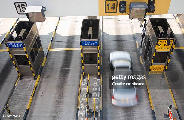 a blurred motion photograph of toll booths - toll booth stock pictures, royalty-free photos & images