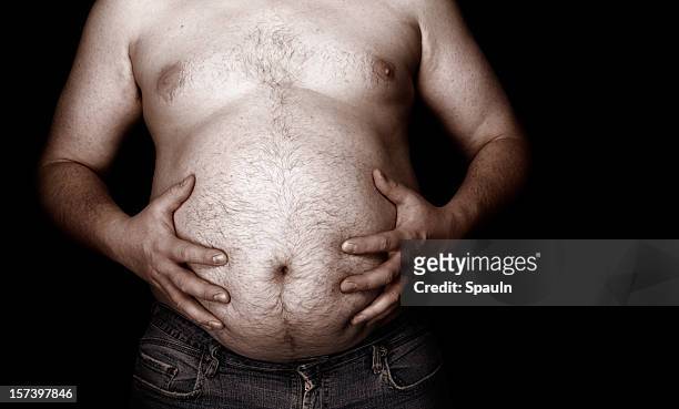 fat man holding his stomach with jeans - bar överkropp bildbanksfoton och bilder
