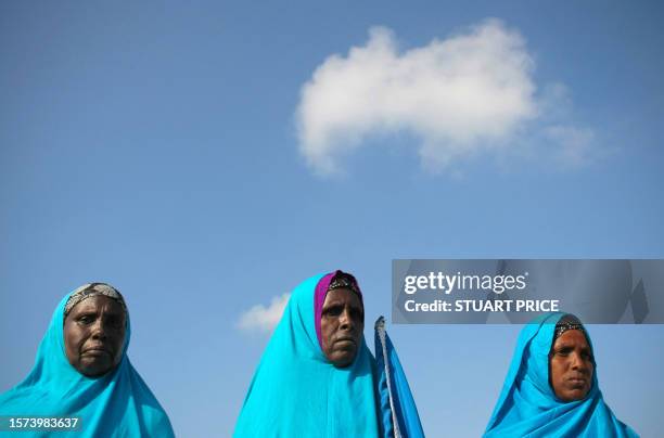 In this photograph released by the African Union-United Nations Information Support Team on March 25 women stand at Mogadishu International Airport...