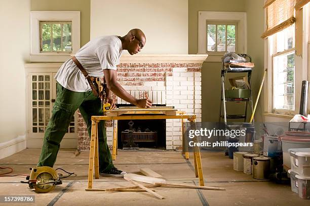 african american man renovating home interior. - home addition stockfoto's en -beelden