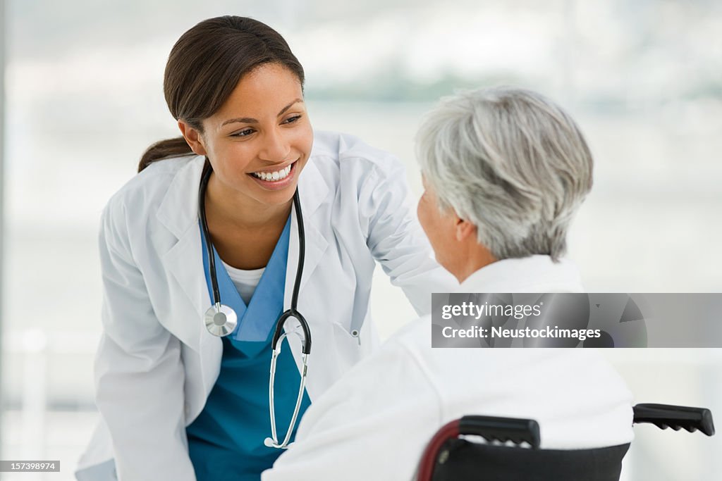 Female doctor talking with senior patient